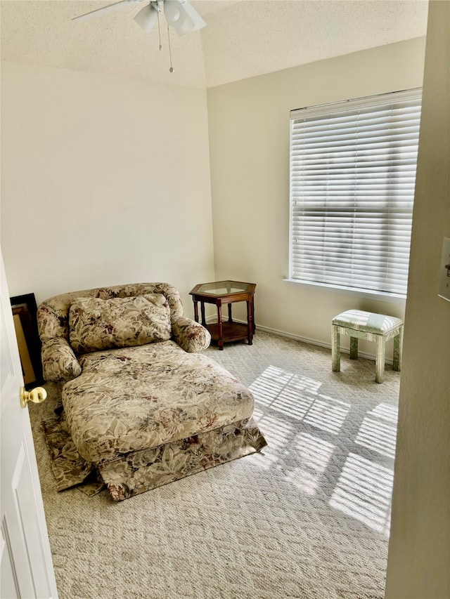 bedroom with light carpet, a textured ceiling, and ceiling fan