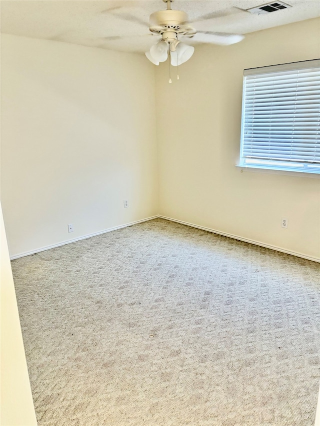 spare room featuring carpet and ceiling fan