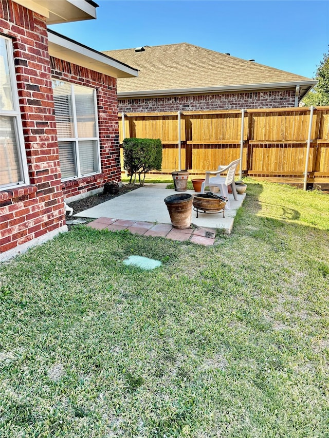 view of yard with a patio and a fire pit