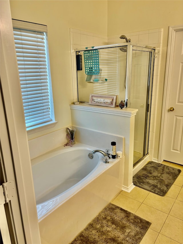 bathroom with tile patterned floors, plenty of natural light, and plus walk in shower