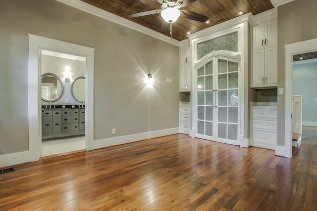 interior space featuring dark wood-type flooring, ceiling fan, crown molding, and wooden ceiling