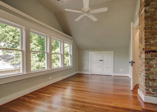 bonus room with light hardwood / wood-style flooring, high vaulted ceiling, a wealth of natural light, and ceiling fan