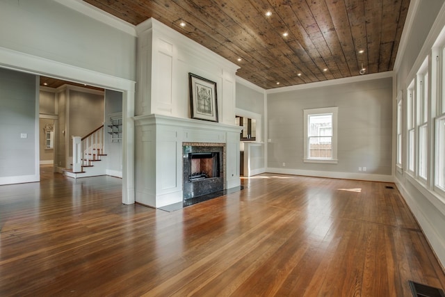 unfurnished living room with a high end fireplace, wood-type flooring, and wooden ceiling