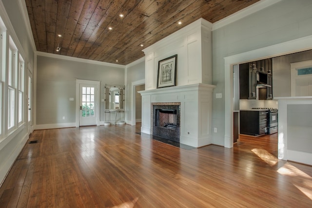 unfurnished living room with wood ceiling, hardwood / wood-style floors, and crown molding