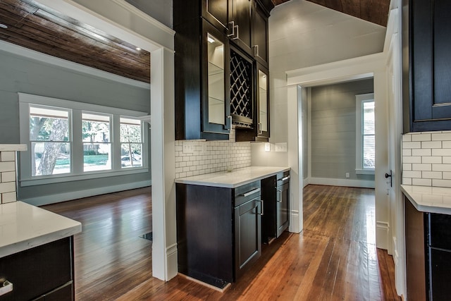 kitchen featuring decorative backsplash, wood ceiling, and dark hardwood / wood-style floors