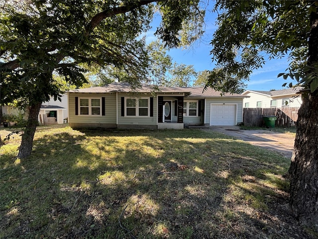 single story home featuring a garage and a front lawn