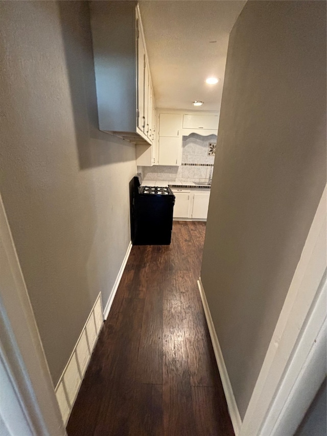 corridor featuring sink and dark hardwood / wood-style flooring