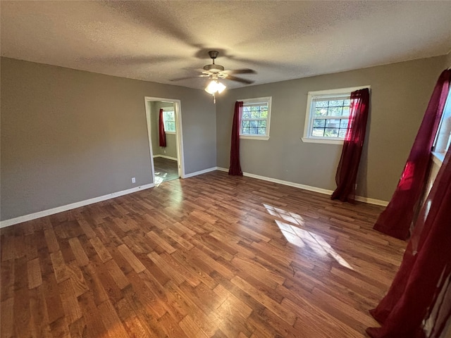 interior space with a textured ceiling, wood-type flooring, and ceiling fan