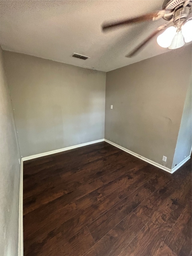 unfurnished room featuring a textured ceiling, ceiling fan, and dark hardwood / wood-style flooring