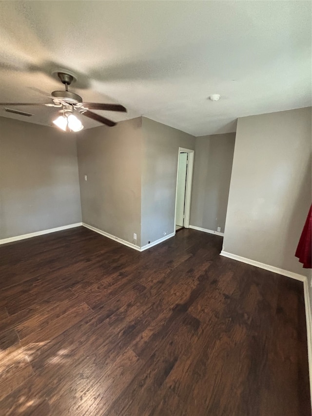 spare room featuring dark hardwood / wood-style floors, a textured ceiling, and ceiling fan