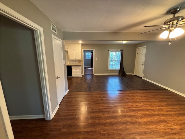 empty room featuring ceiling fan and dark hardwood / wood-style flooring