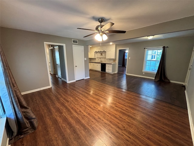 unfurnished living room featuring sink, dark hardwood / wood-style floors, and ceiling fan