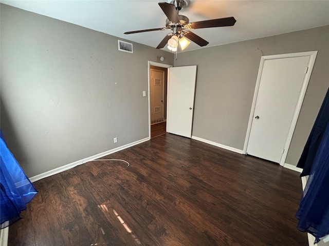 unfurnished bedroom with ceiling fan and dark hardwood / wood-style floors