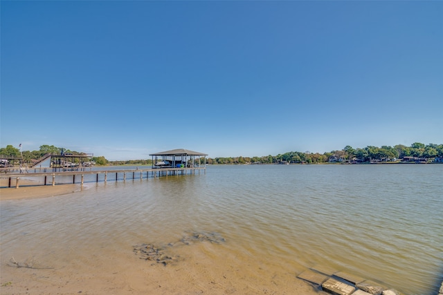 view of dock featuring a gazebo and a water view