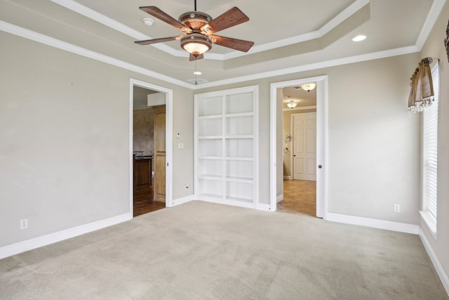 unfurnished bedroom with ceiling fan, ornamental molding, multiple windows, and light colored carpet