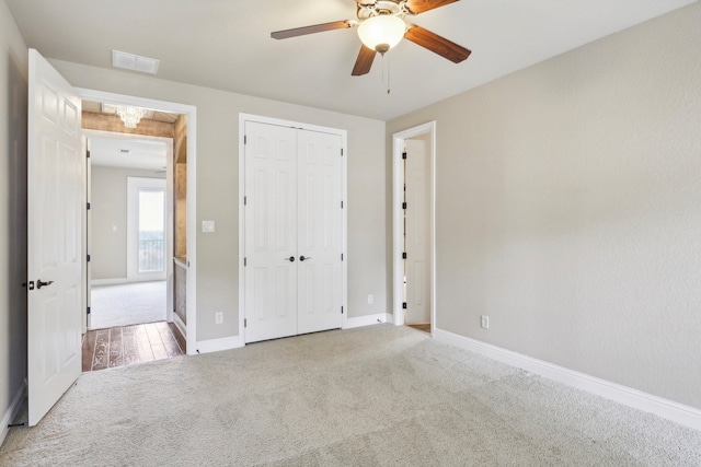 unfurnished bedroom with a closet, ceiling fan, and carpet flooring