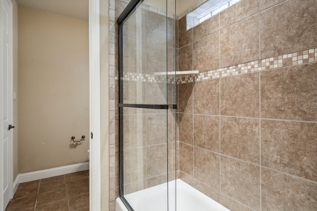 bathroom featuring a shower with door and tile patterned floors