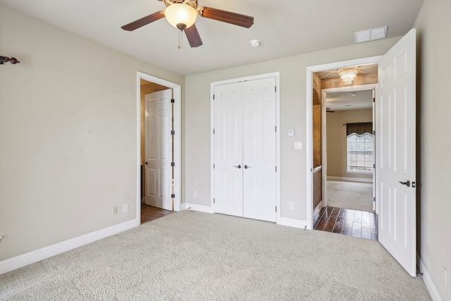 unfurnished bedroom with dark carpet, a closet, and ceiling fan