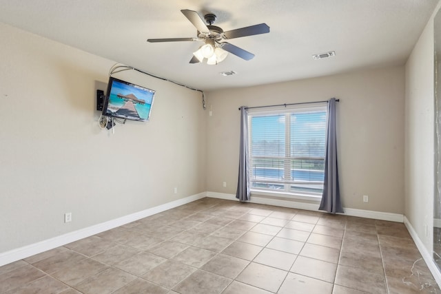 tiled empty room with ceiling fan