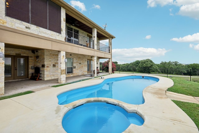 view of pool with an in ground hot tub and a patio area