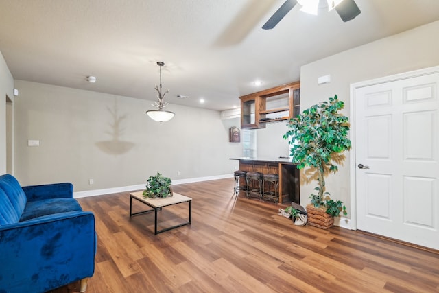 living room featuring ceiling fan and wood-type flooring