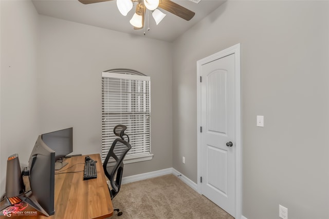 carpeted office space with ceiling fan