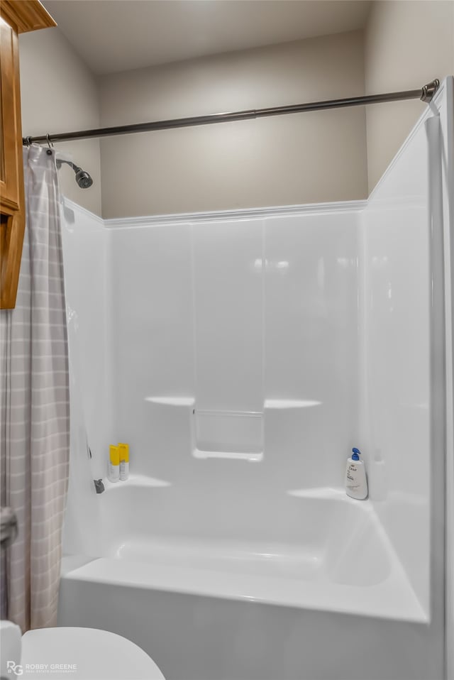 bathroom with toilet and shower / tub combo