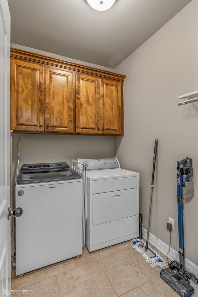 laundry area with light tile patterned flooring, independent washer and dryer, and cabinets