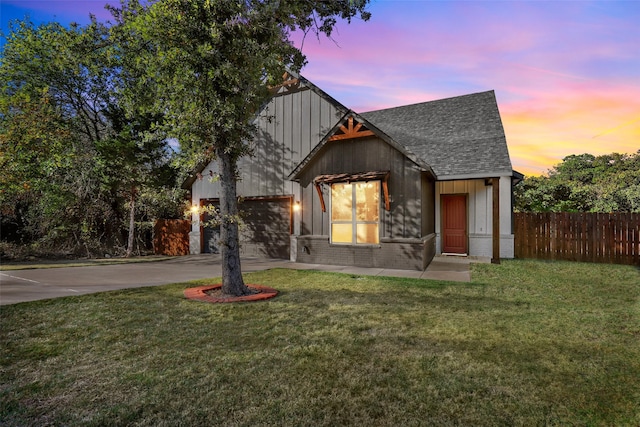 view of front of house with a yard and a garage