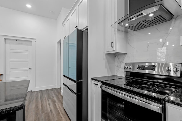 kitchen featuring wall chimney exhaust hood, white cabinetry, stainless steel appliances, and light wood-type flooring