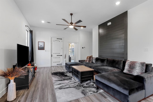 living room featuring hardwood / wood-style flooring and ceiling fan