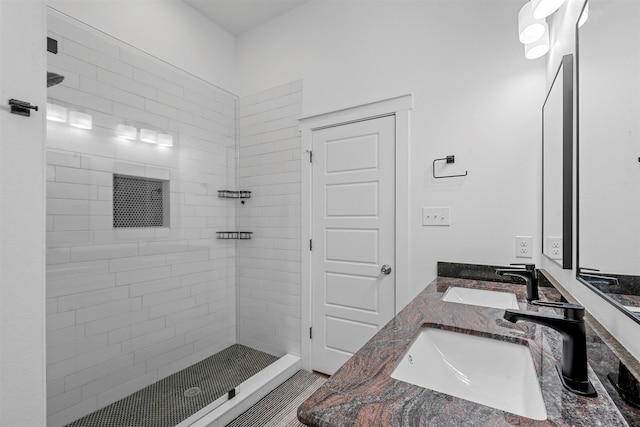 bathroom with vanity and a tile shower