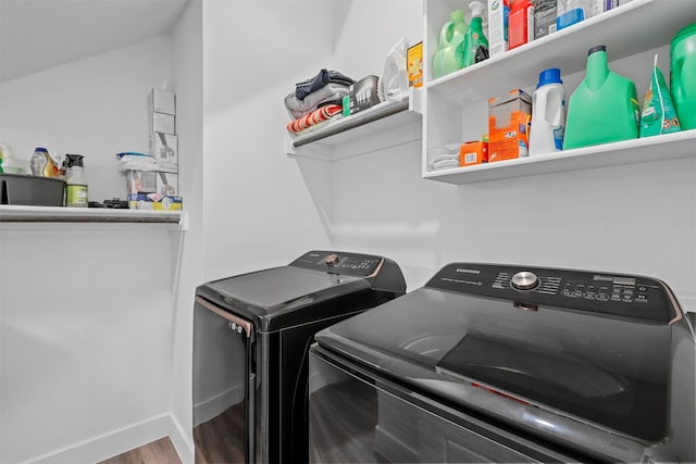 laundry room with washing machine and dryer and hardwood / wood-style floors