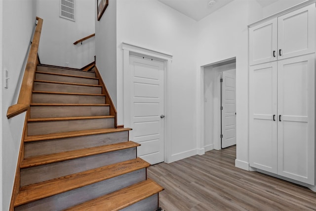 stairway with hardwood / wood-style flooring