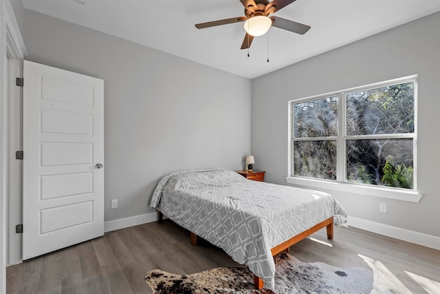 bedroom featuring hardwood / wood-style floors and ceiling fan