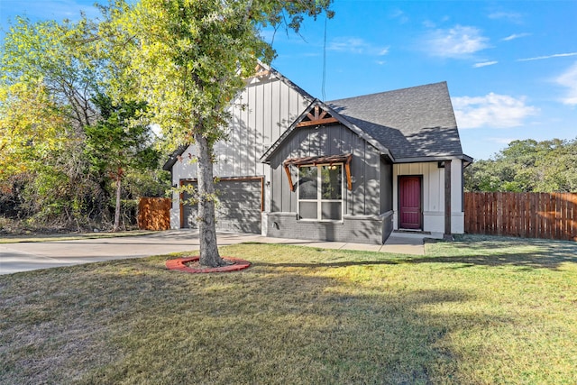 view of front of house with a front yard and a garage