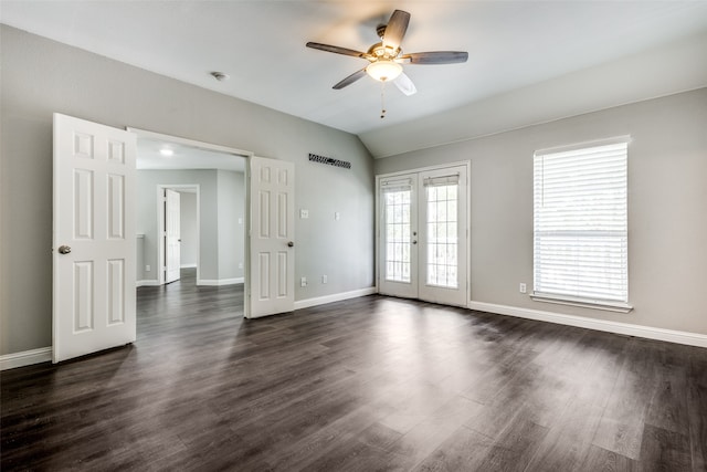 empty room featuring dark wood-type flooring, vaulted ceiling, french doors, and ceiling fan