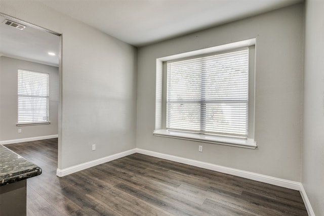 spare room featuring dark hardwood / wood-style floors