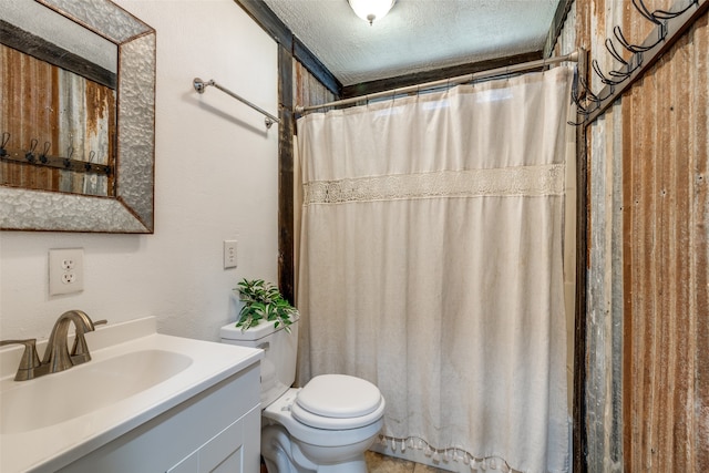 bathroom featuring vanity, a textured ceiling, toilet, and walk in shower