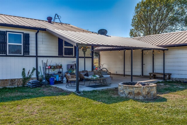 rear view of property featuring outdoor lounge area, a patio, and a lawn