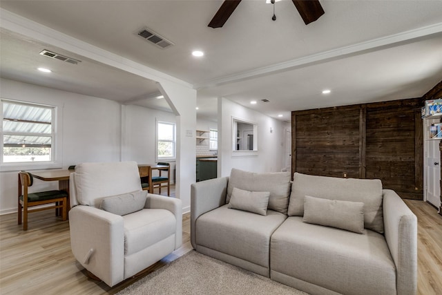 living room featuring light hardwood / wood-style floors, ceiling fan, and a healthy amount of sunlight