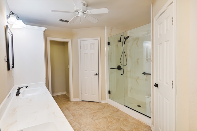 bathroom featuring a shower with door, ceiling fan, and vanity