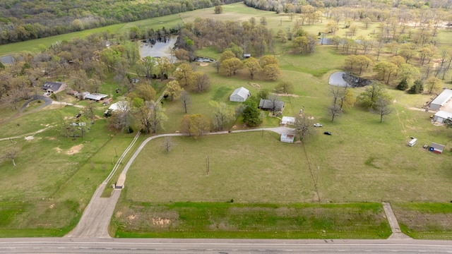 birds eye view of property with a water view and a rural view