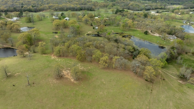 drone / aerial view featuring a water view and a rural view