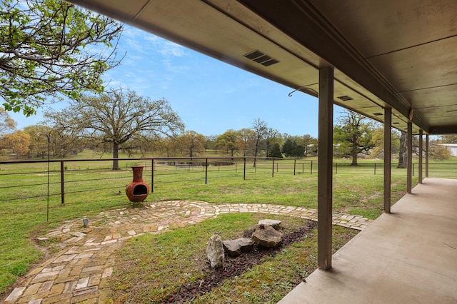 view of yard featuring a patio, fence, and visible vents