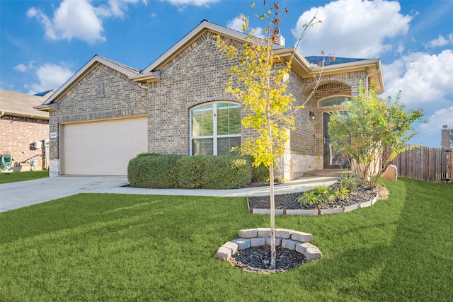 view of front of house with a garage and a front lawn