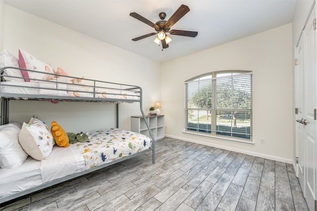 bedroom with light hardwood / wood-style floors and ceiling fan