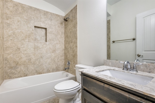 full bathroom with vanity, toilet, and tiled shower / bath