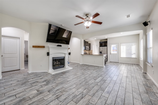 unfurnished living room with ceiling fan and light hardwood / wood-style floors