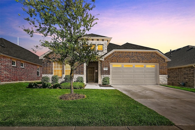 view of front of home with a garage and a yard